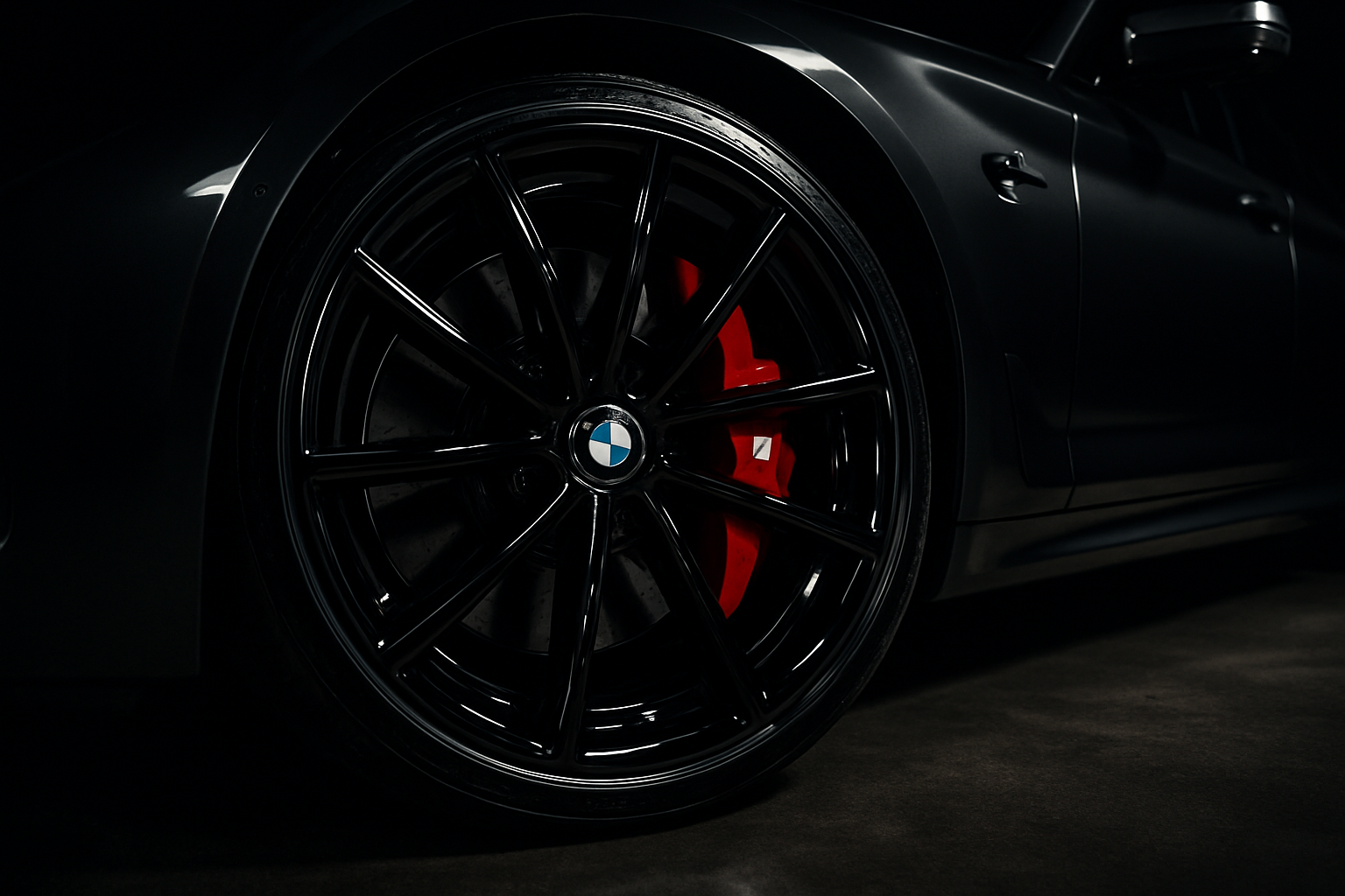 A pristine, ceramic-coated wheel and brake caliper on a luxury car, showcasing the specialized protection services offered by Major Detailz in Houston.